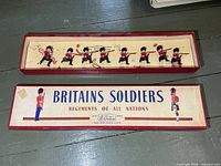 Full view of open box showing all eight soldiers and lid
