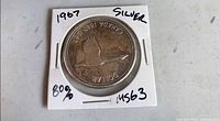 Obverse in cardboard holder showing Canada goose reverse and inscriptions