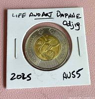 Obverse side of 2025 Daphne Odjig $2 coin in flip