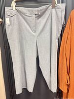 Full view of light grey capri pants on hanger