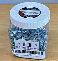 Front of jar showing nuts, lid logo and factory label