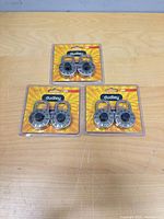 Three sealed twin-packs of Dudley combination padlocks on tabletop