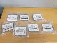 Seven sealed packages of Lithonia aircraft cables displayed on table