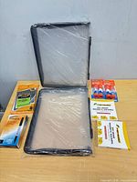 All items laid out: two dry erase pockets, glue sticks, magnetic square boxes, BIC pens, Integra marker