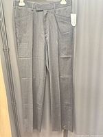 Full view of the dress pants hanging to show overall condition and style