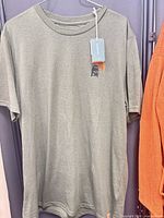Front view of olive green Tentree T-shirt with hang tag