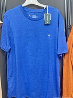 Full front view of blue Tentree T-shirt on hanger with tag