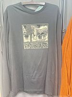 Full front view of black long sleeve T-shirt with graphic