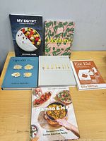 All six cookbooks front covers on table