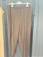 Full view of brown pants on hanger
