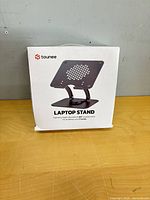 Front of boxed Tounee laptop stand showing product image and branding