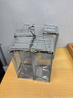 Four metal mesh mouse traps grouped on table