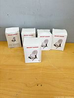 Five sealed boxes labeled Bracket Charger on table