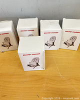 Front view of five boxed bracket chargers