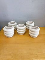 Five matching spiral planters on table