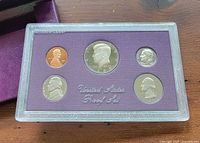 Obverse of five proof coins in plastic case