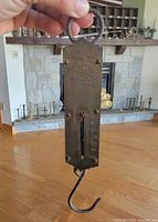 Front view showing brand stamping, graduated scale up to 50 lb, top ring and bottom hook