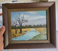 Front view of framed landscape painting