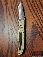 Knife open showing blade shape, handle texture and inlay