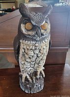 Front view showing entire owl statue with painted details and size perspective