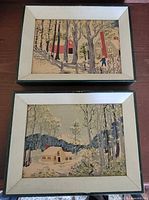 Both framed Grandma Moses prints side by side