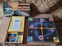 Closed box, open tray showing components, folded game board