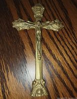 front view of brass crucifix showing ornate details
