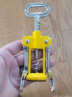 Front view of yellow Pedrini wing corkscrew showing handle, worm, wings