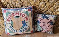 Both pig-themed pillows side by side