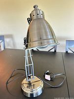 Full view of brushed nickel adjustable desk lamp with cord