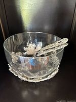 Glass punch bowl on silver-tone stand with ladle inside