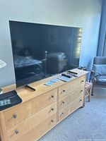 Front view of 65-inch Samsung QLED TV on dresser