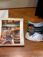 Both signed items—photo and poster—laid flat