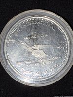 Obverse of medal in capsule showing aircraft and inscriptions