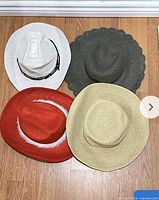 Top view of all four hats showing colours and brim shapes