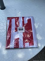 Sealed flag package front view showing folded red and white design