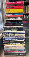 Stack of 36 magic books showing spines and titles