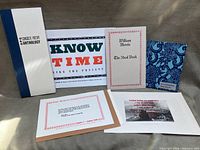 All six Lexikon Press items laid out: anthology, broadside, William Morris booklet, Re-inhabitation, Great Sentences envelope, Bodhisattva Vow print