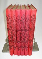 Front view of six red Almanach Vermot volumes showing spines and years