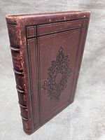 Front cover showing brown leather binding with black embossed panel