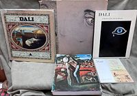 Group shot of all five Salvador Dali books standing and lying flat