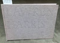 Front view of cloth hardcover showing embossed title