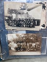Two photo sleeves showing large group portraits on warship deck and outdoor setting