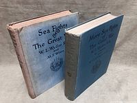 Both hardcover volumes standing upright showing front boards and spines