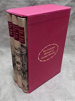 Three volumes in pink slipcase, spines facing