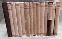 14 hardcover volumes lined up showing dust jackets and spines