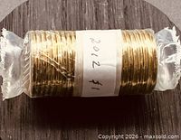 Full roll wrapped in clear plastic with hand-written 2012 $1 label
