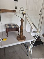 All three items: metal swing-arm floor lamp, wood pedestal and plaid footstool