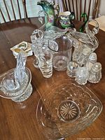 Group view of all clear pressed glass items on table