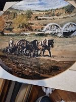 Front view of porcelain plate showing painted rural scene
